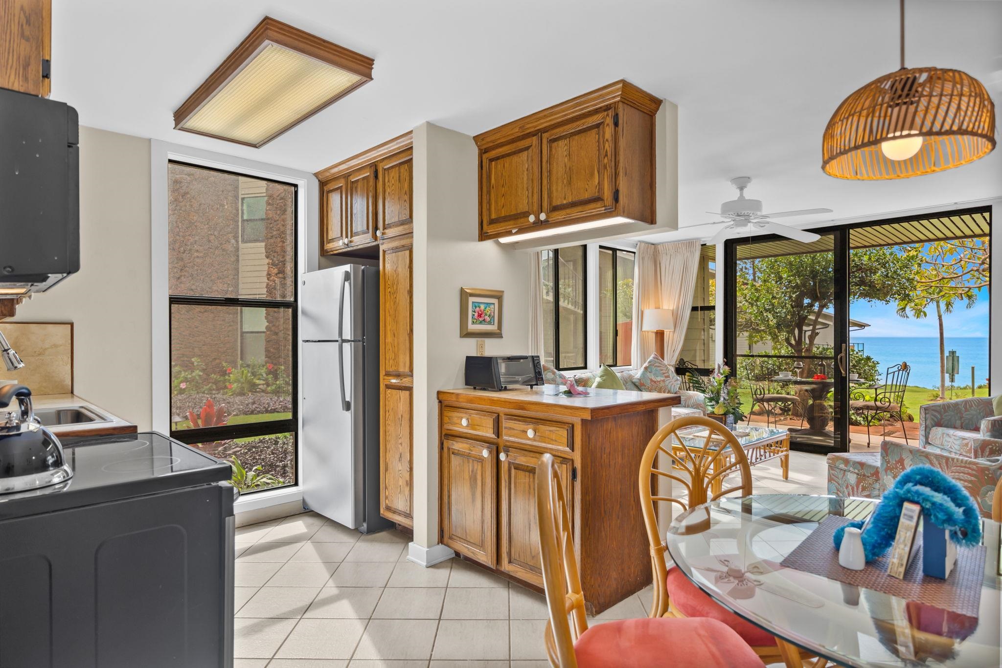 4057 Lower Honoapiilani Road, Unit 116 Lahaina, HI 96761 - Photo 20 of 38 a kitchen with stainless steel appliances granite countertop a stove and a refrigerator