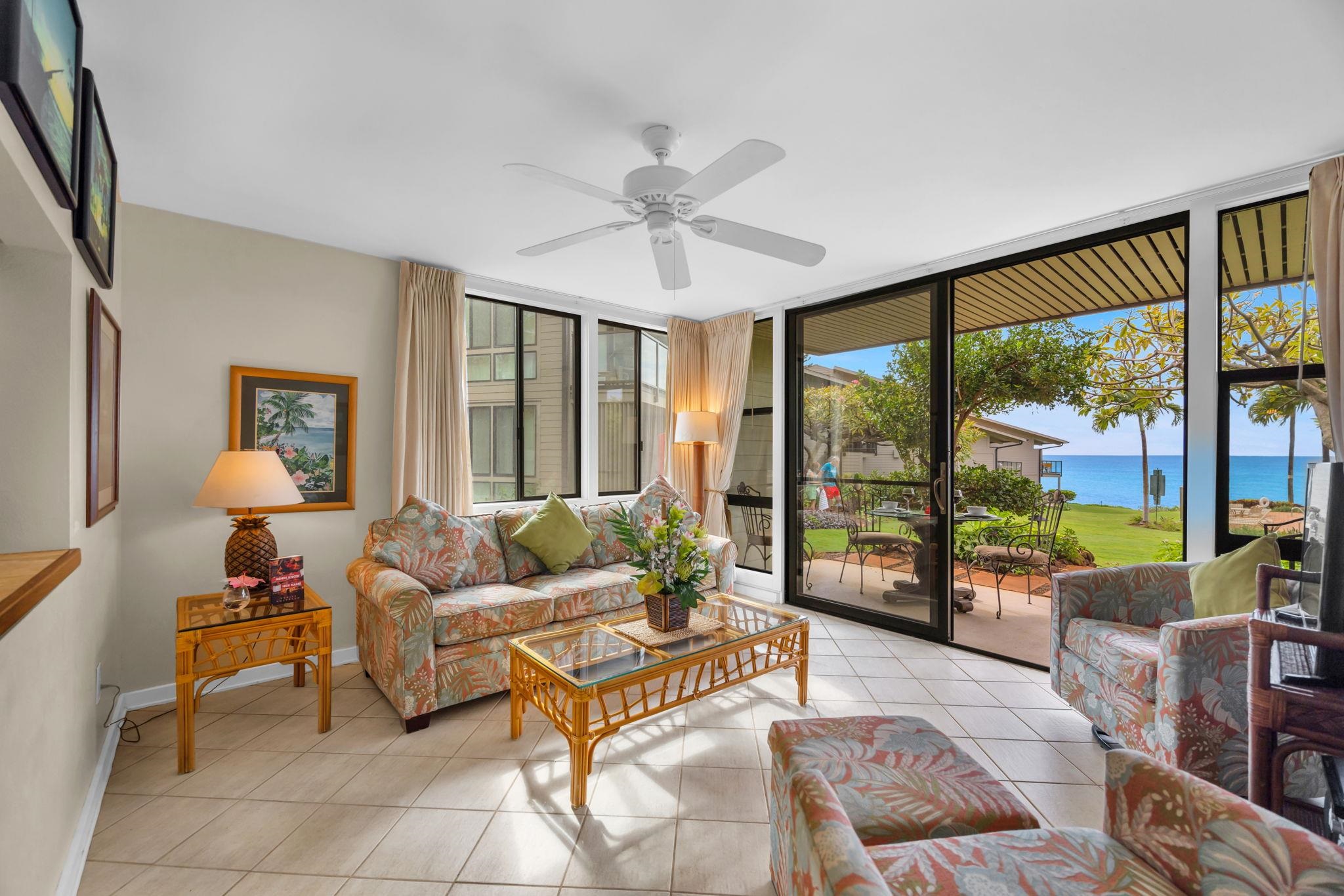 4057 Lower Honoapiilani Road, Unit 116 Lahaina, HI 96761 - Photo 2 of 38 a living room with furniture and a large window with balcony view