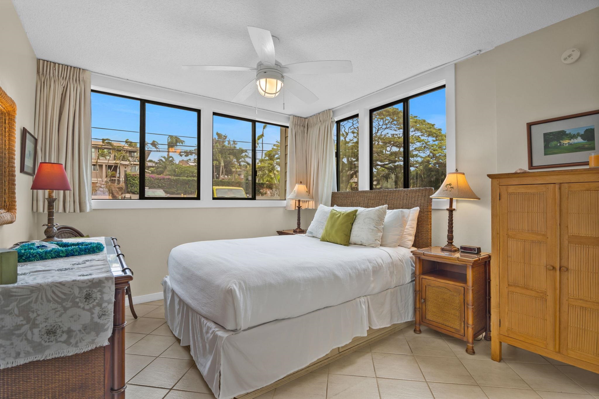 4057 Lower Honoapiilani Road, Unit 116 Lahaina, HI 96761 - Photo 6 of 38 a bedroom with a bed and a dresser next to a window