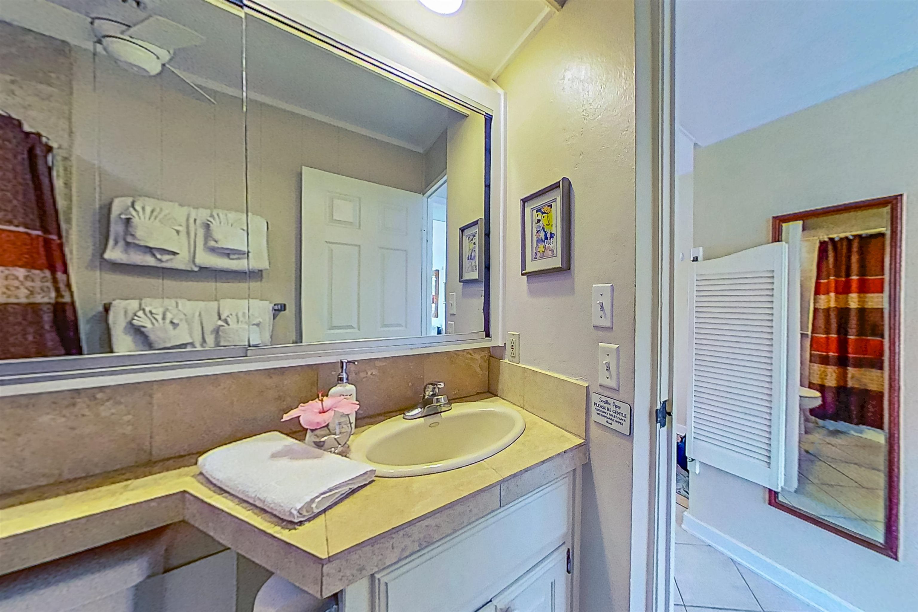 4057 Lower Honoapiilani Road, Unit 116 Lahaina, HI 96761 - Photo 7 of 38 a bathroom with a sink and a mirror