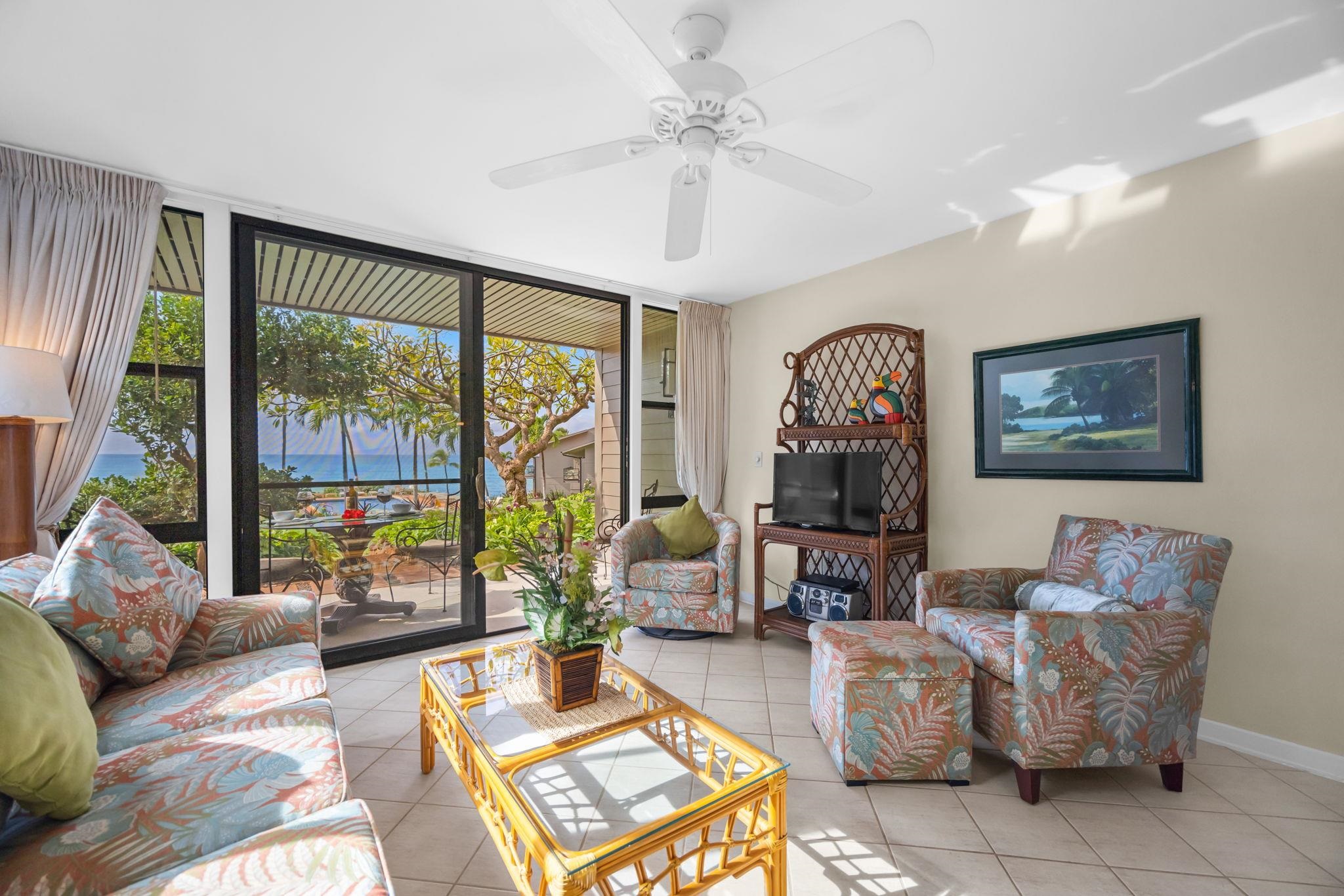 4057 Lower Honoapiilani Road, Unit 116 Lahaina, HI 96761 - Photo 10 of 38 a living room with furniture and a large window