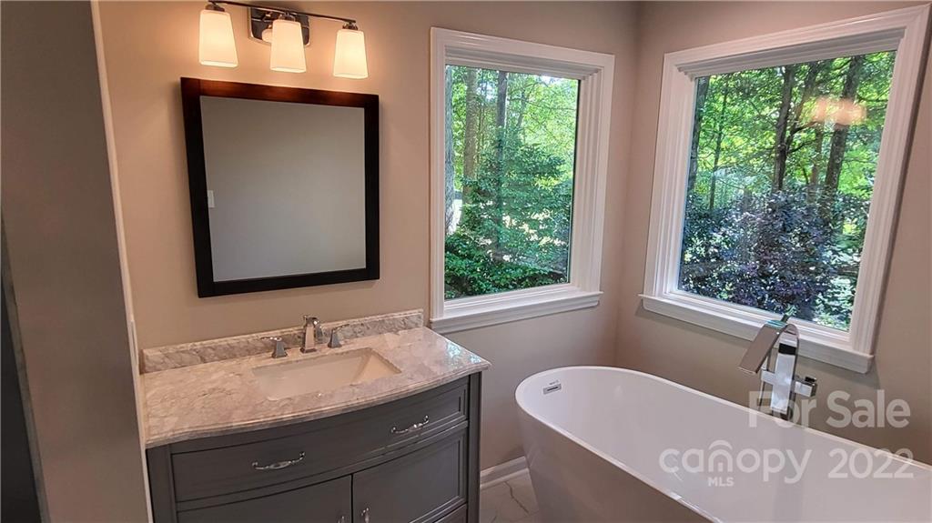 4324 Dye Road Edgemoor, SC 29712 - Photo 13 of 33 a bathroom with a granite countertop sink mirror and a window
