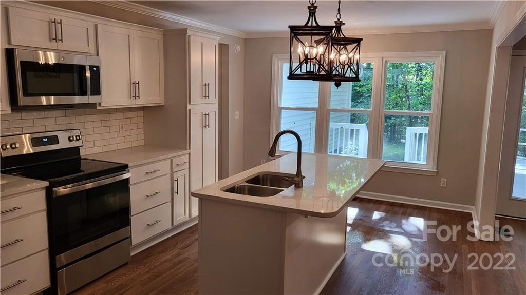 4324 Dye Road Edgemoor, SC 29712 - Photo 3 of 33 a kitchen with stainless steel appliances granite countertop a stove a sink and a microwave