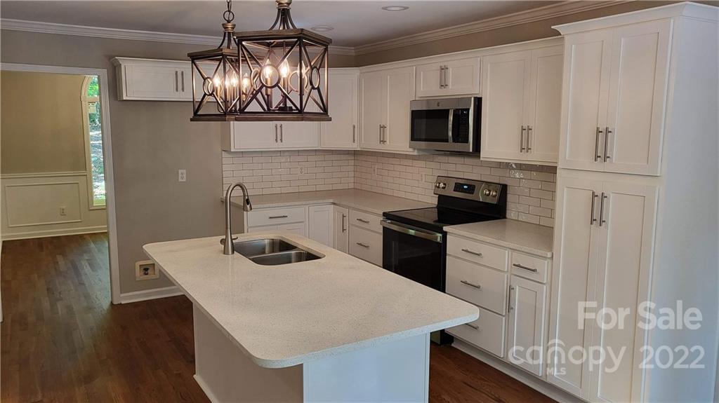 4324 Dye Road Edgemoor, SC 29712 - Photo 6 of 33 a kitchen with a sink a microwave a stove and refrigerator