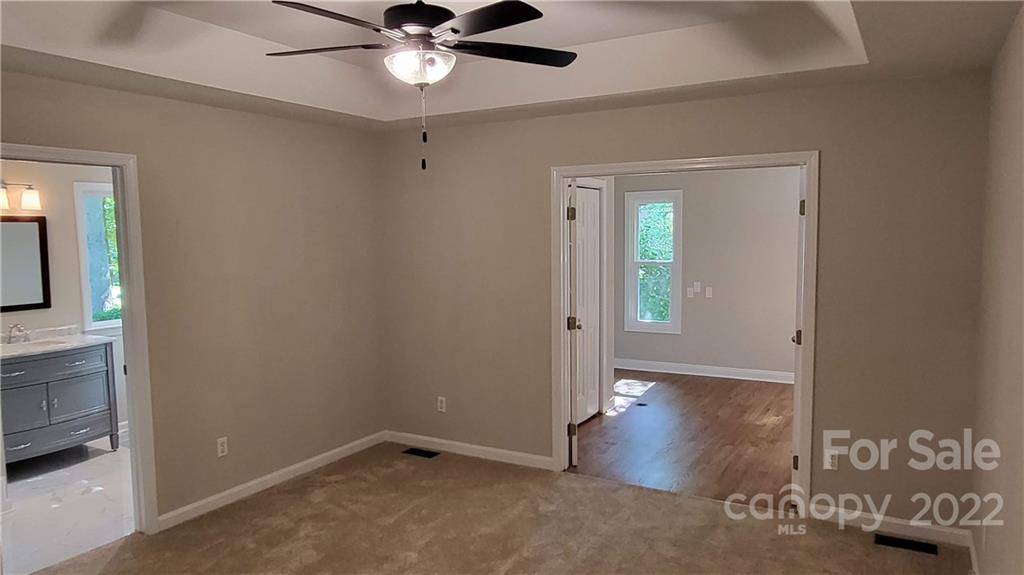 4324 Dye Road Edgemoor, SC 29712 - Photo 7 of 33 an empty room with wooden floor and mirror