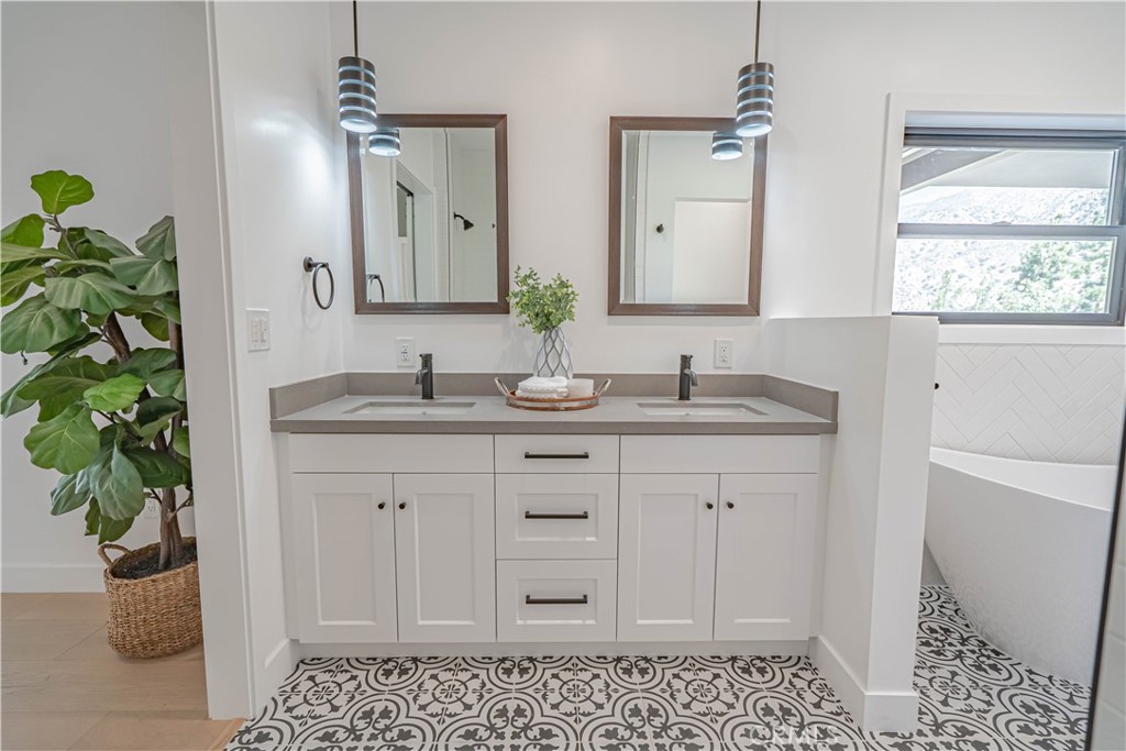 4134 Big Tujunga Canyon Road Tujunga, CA 91042 - Photo 24 of 44 a bathroom with a granite countertop sink a mirror a vanity and a window