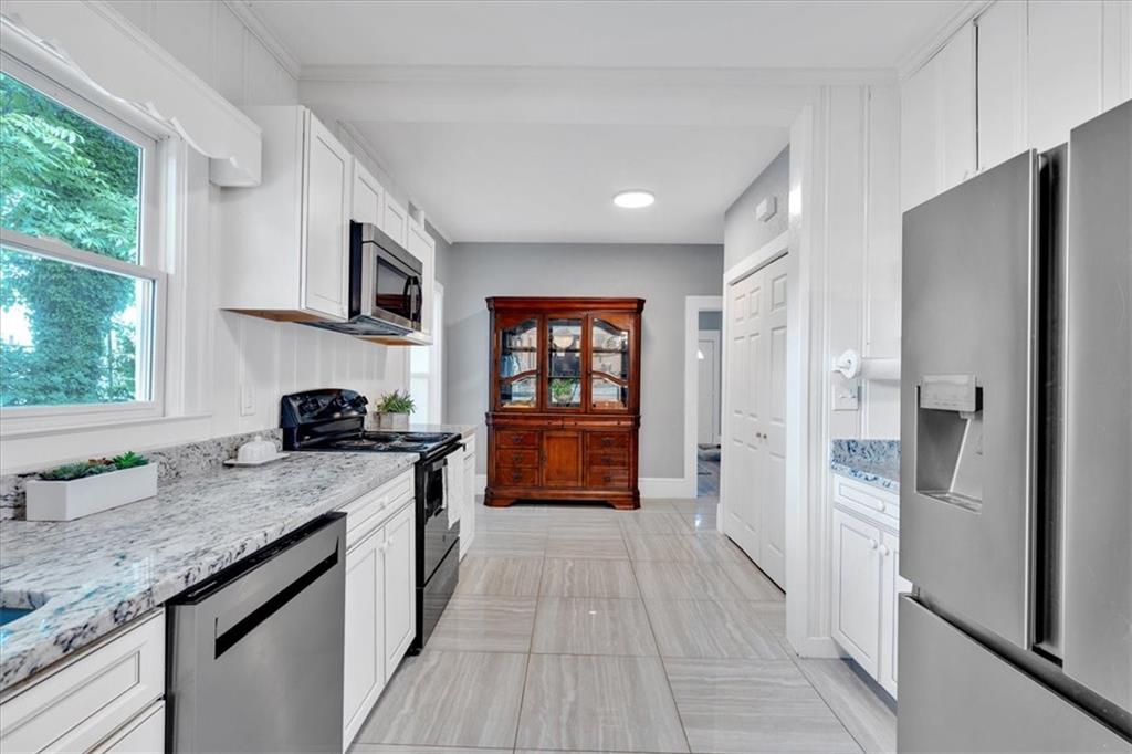 8 South Hughes Street Rome, GA 30165 - Photo 9 of 28 a kitchen with stainless steel appliances granite countertop a sink stove and refrigerator
