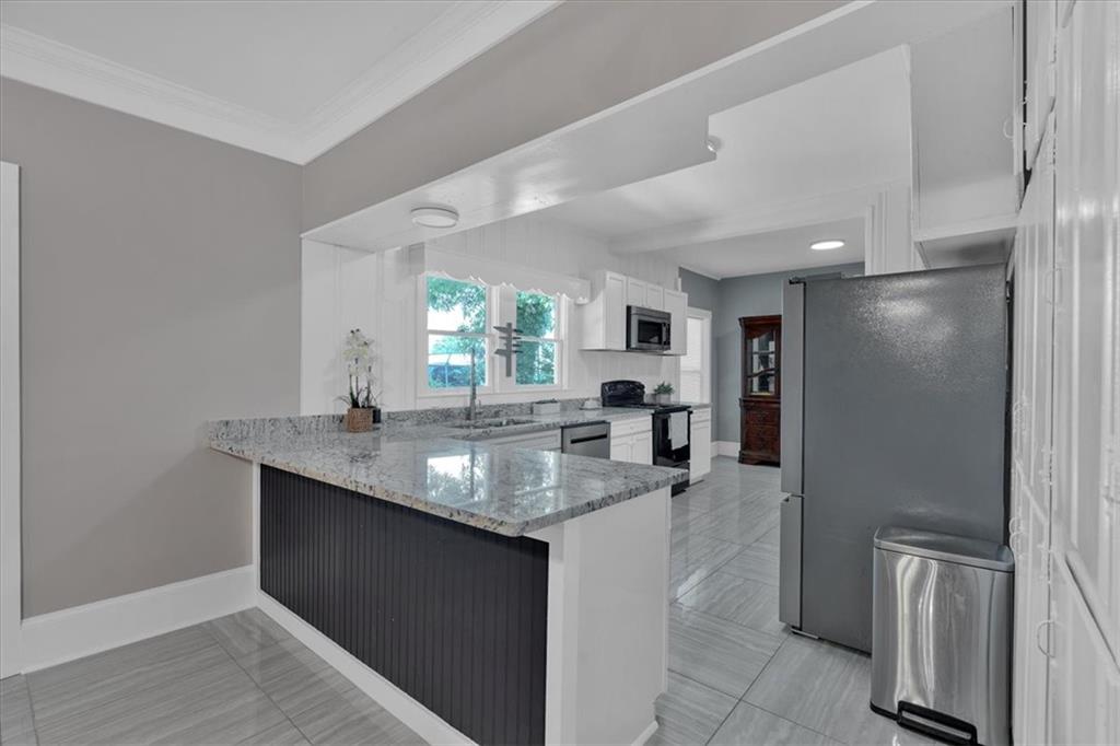 8 South Hughes Street Rome, GA 30165 - Photo 10 of 28 a kitchen with granite countertop a sink stove and refrigerator