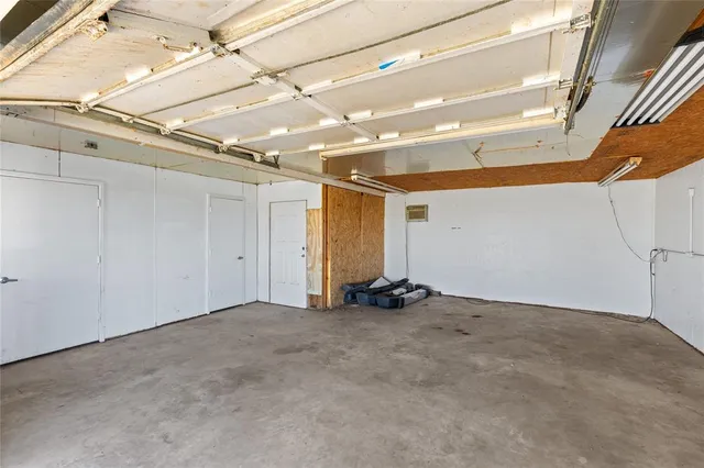 a view of hallway with chandelier and a window
