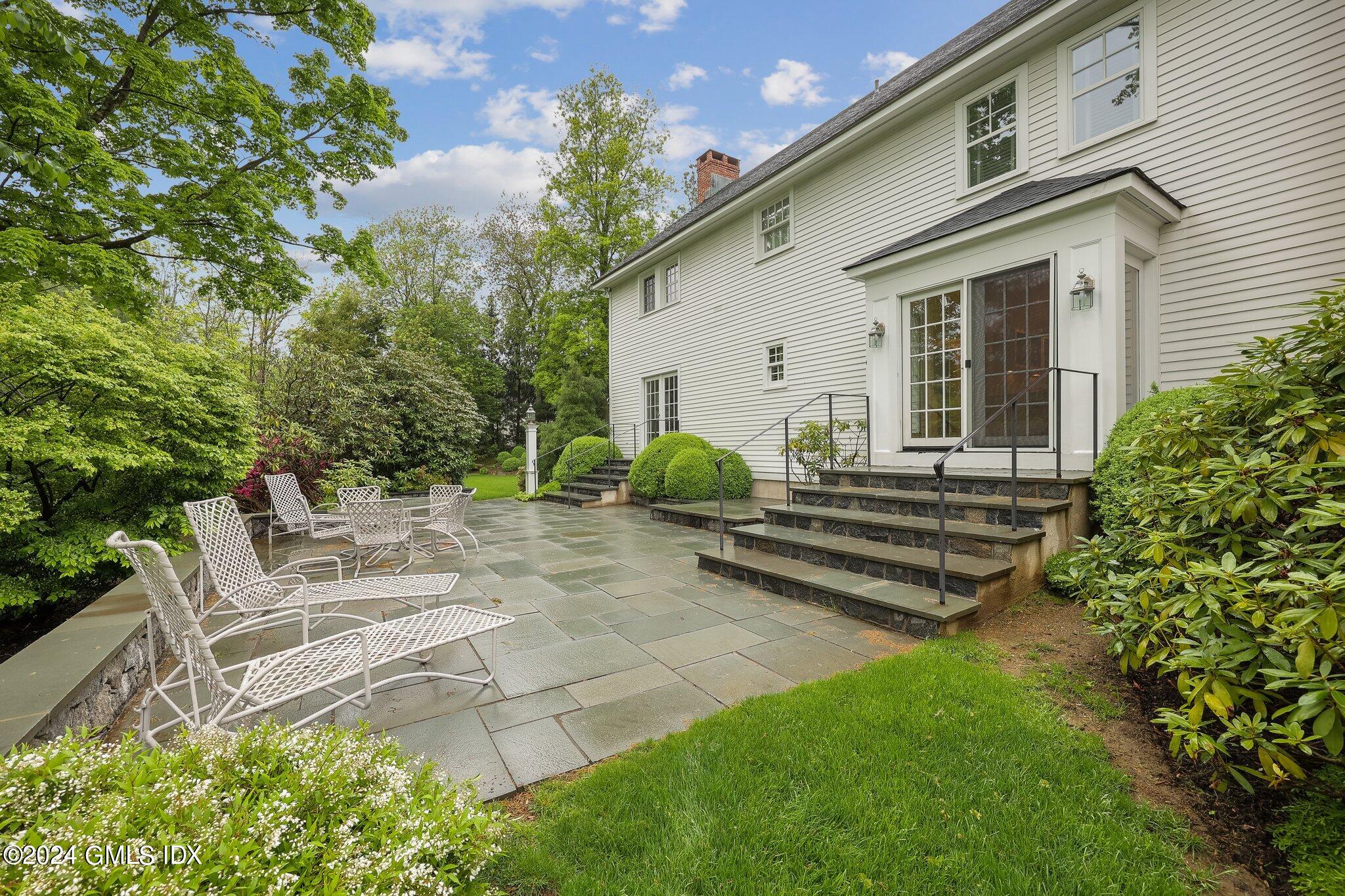 87 Dingletown Road Greenwich, CT 06830 - Photo 54 of 65 a view of a house with backyard and sitting area