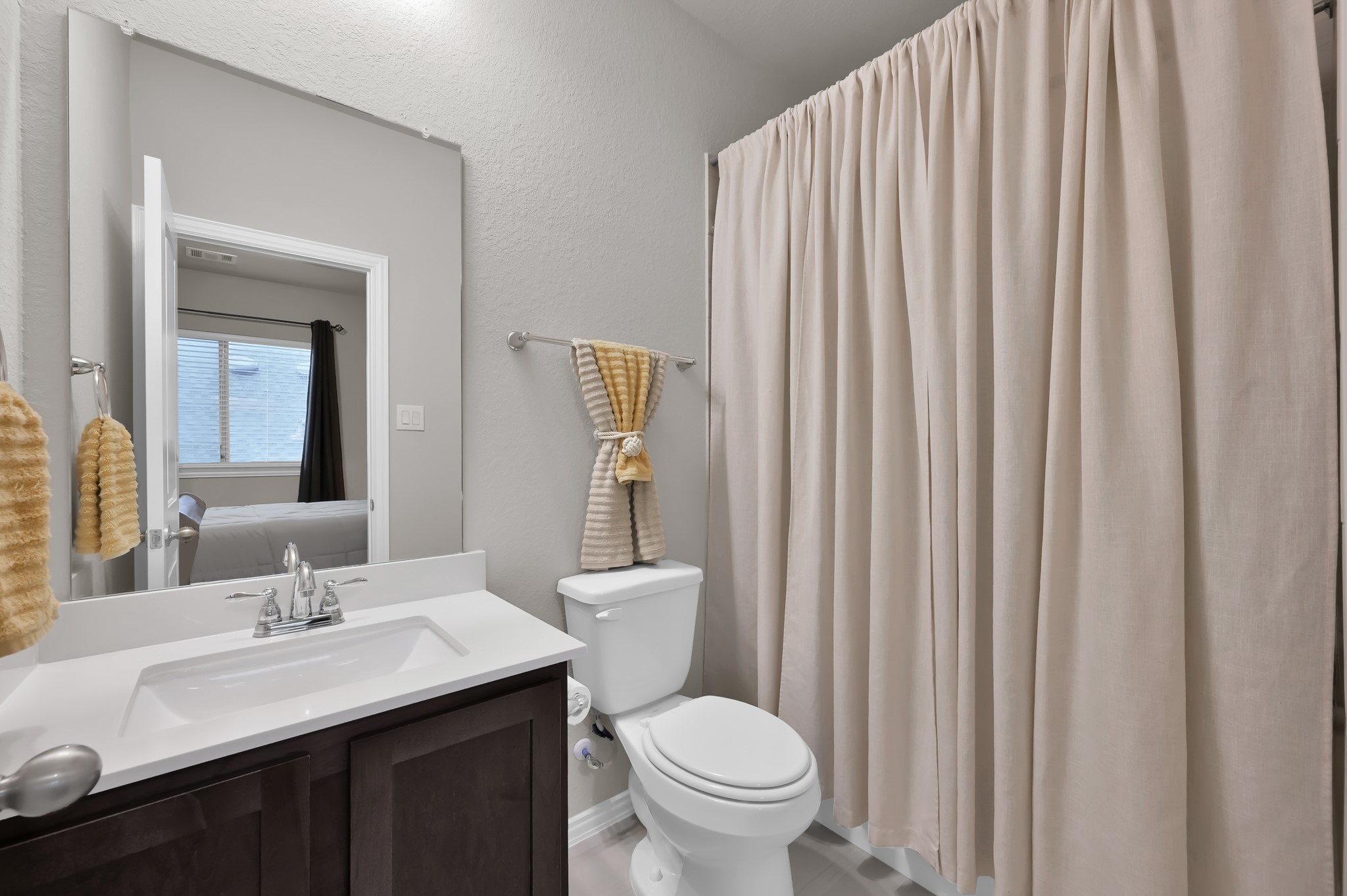 17413 Turtleweed Lane Conroe, TX 77385 - Photo 14 of 27 a bathroom with a toilet a sink and a mirror