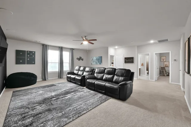 a living room with furniture and a large mirror