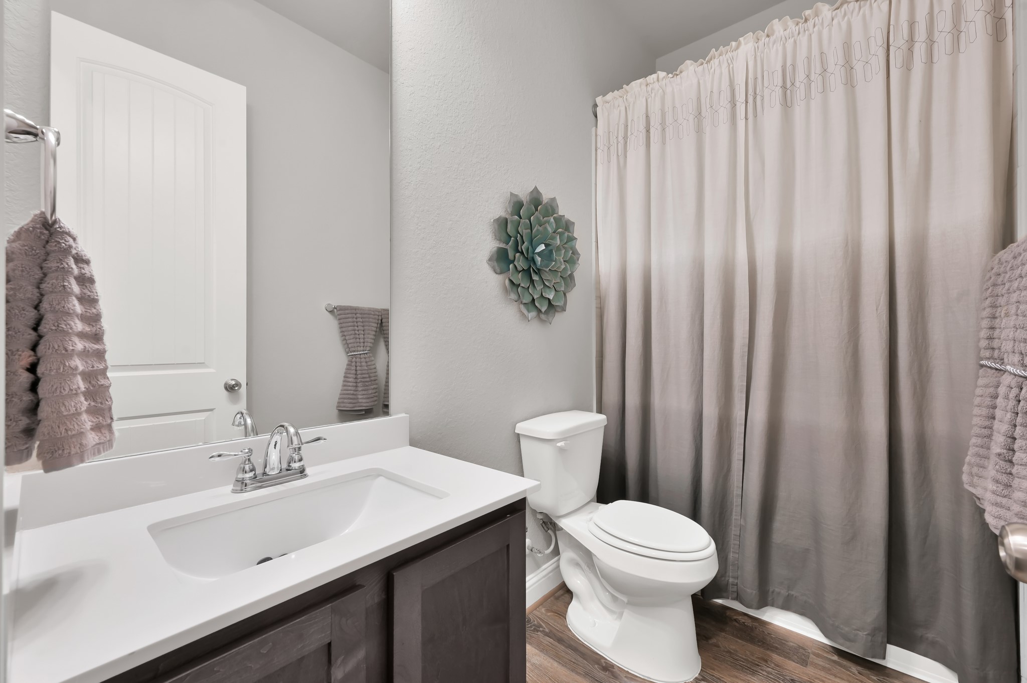 17413 Turtleweed Lane Conroe, TX 77385 - Photo 17 of 27 a bathroom with a toilet a sink and a mirror