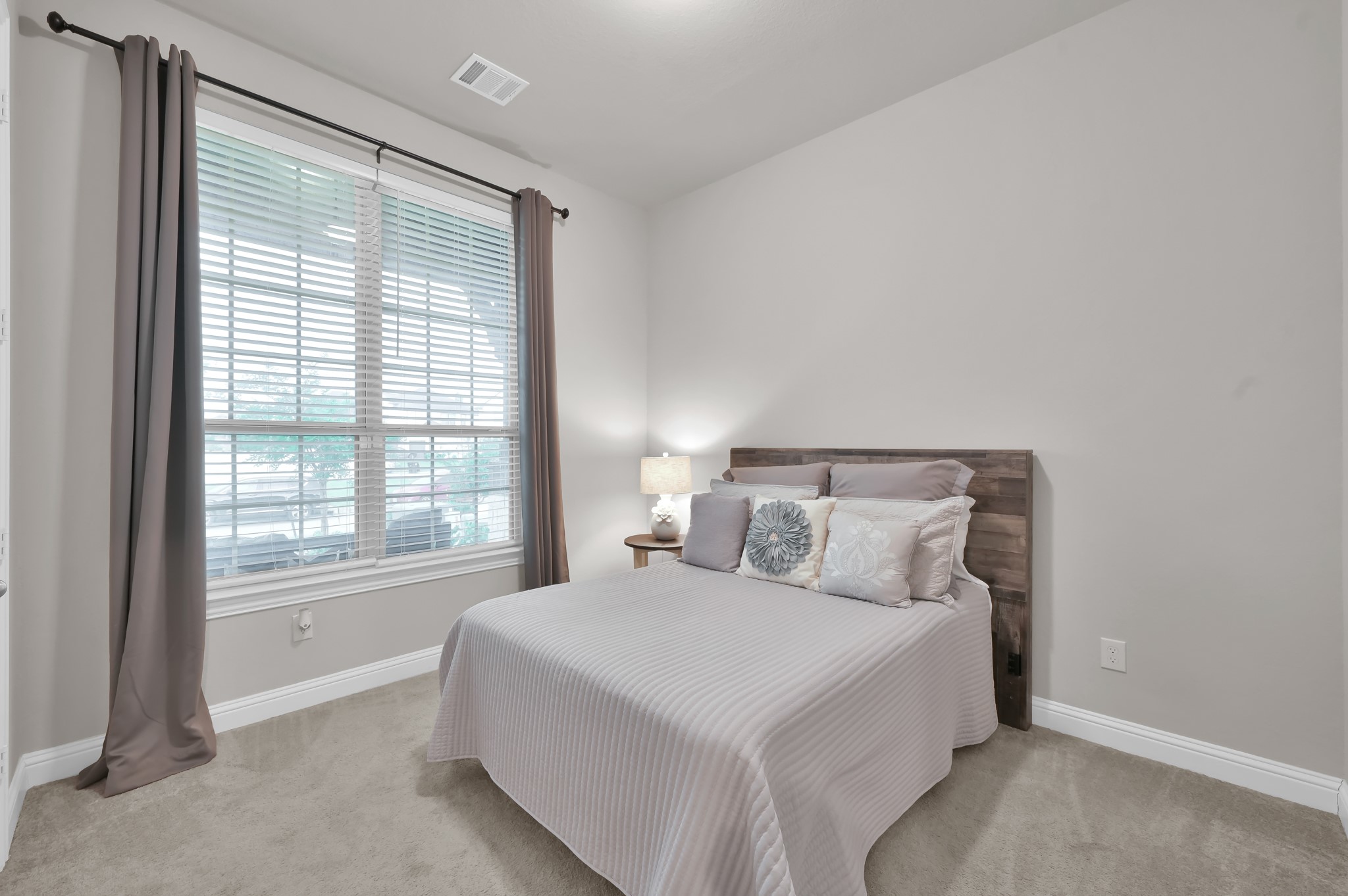 17413 Turtleweed Lane Conroe, TX 77385 - Photo 18 of 27 a bedroom with a bed and a large window