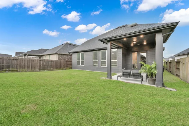 a view of an house with backyard and porch