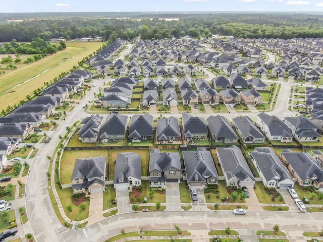 an aerial view of residential houses with outdoor space
