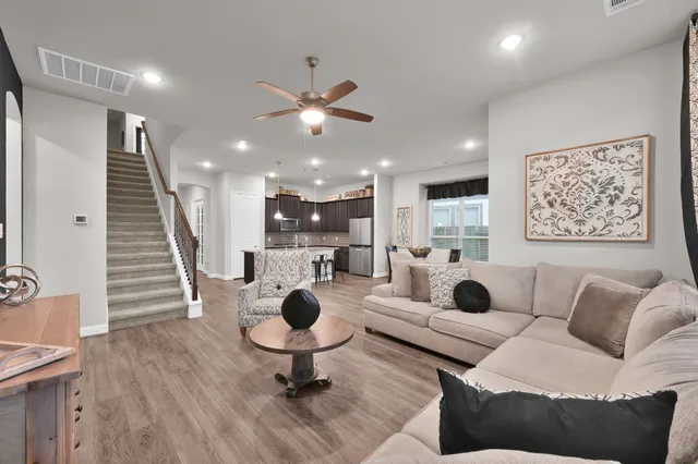 a living room with furniture and kitchen view