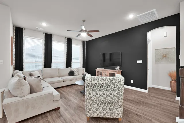 a living room with furniture and a large window