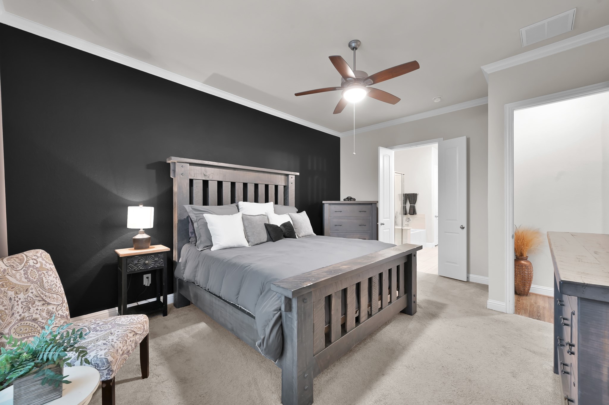 17413 Turtleweed Lane Conroe, TX 77385 - Photo 8 of 27 a bedroom with a bed and a chandelier