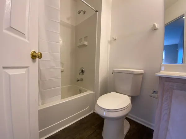 a bathroom with a toilet and a shower