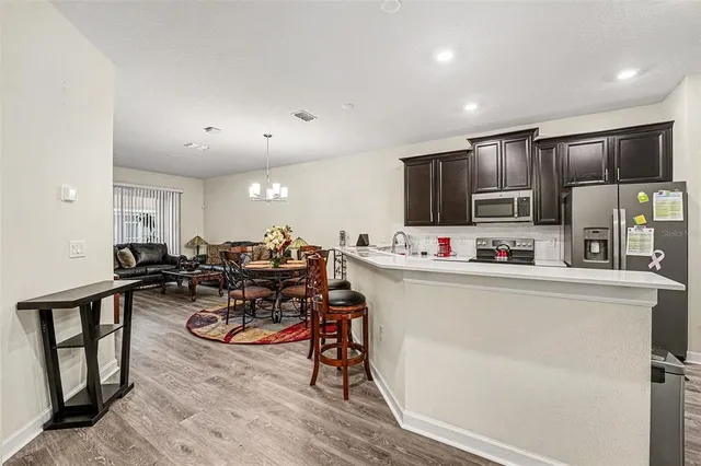 a view of a kitchen with sink microwave and cabinets