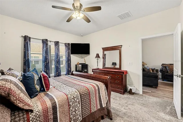 a bedroom with a bed and a chandelier