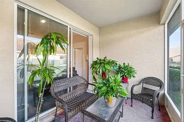 a vase of flowers sitting on a table in front of a window