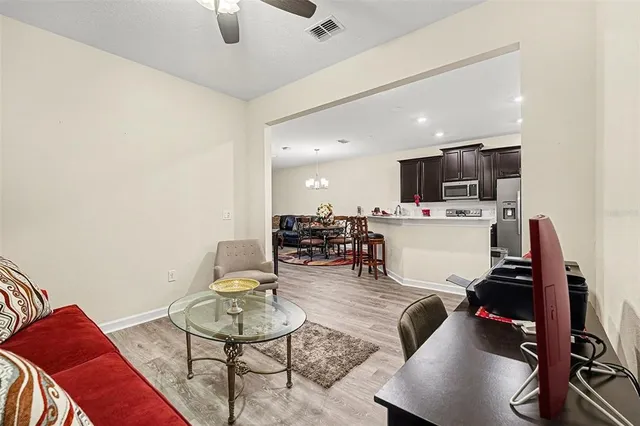 a living room with furniture and kitchen view