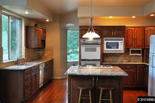 10 Promontory Pointe Reno, NV 89519 - Photo 4 of 13 a kitchen with stainless steel appliances granite countertop a sink and a refrigerator
