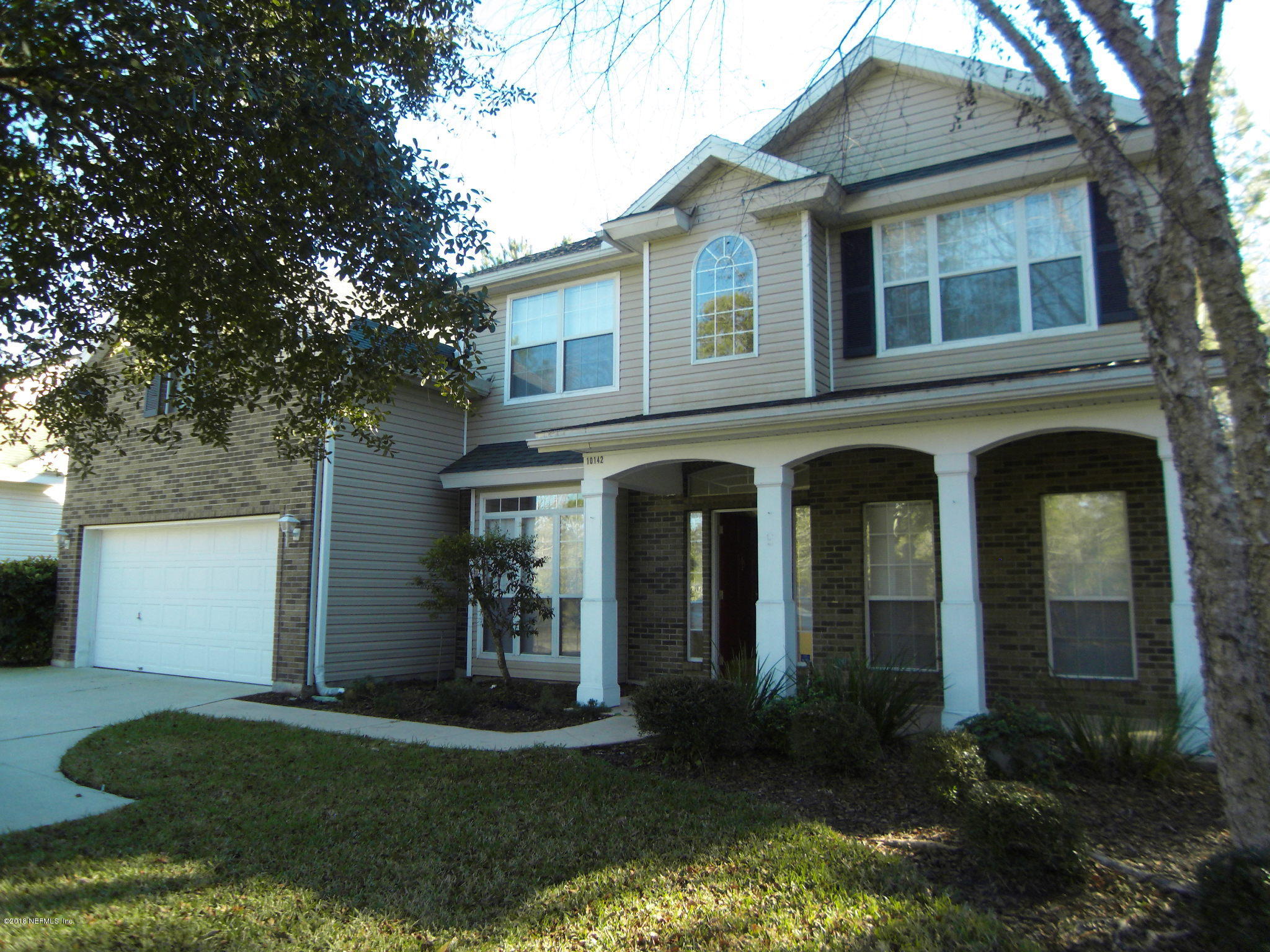 10142 Sandler Road Jacksonville, FL 32222 - Photo 1 of 33 a front view of a house with garden