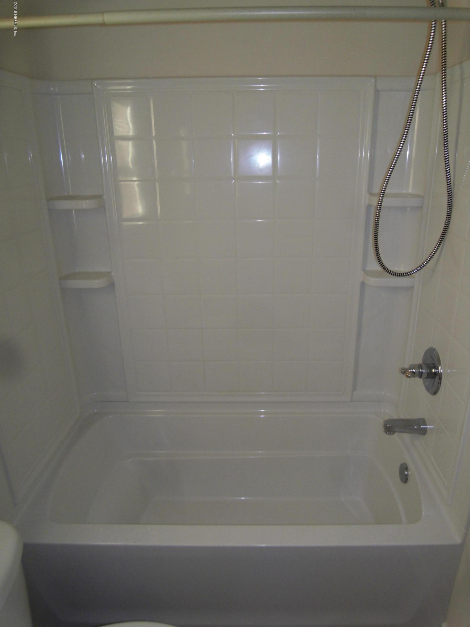 10142 Sandler Road Jacksonville, FL 32222 - Photo 15 of 33 a bathroom with a shower and a bathtub