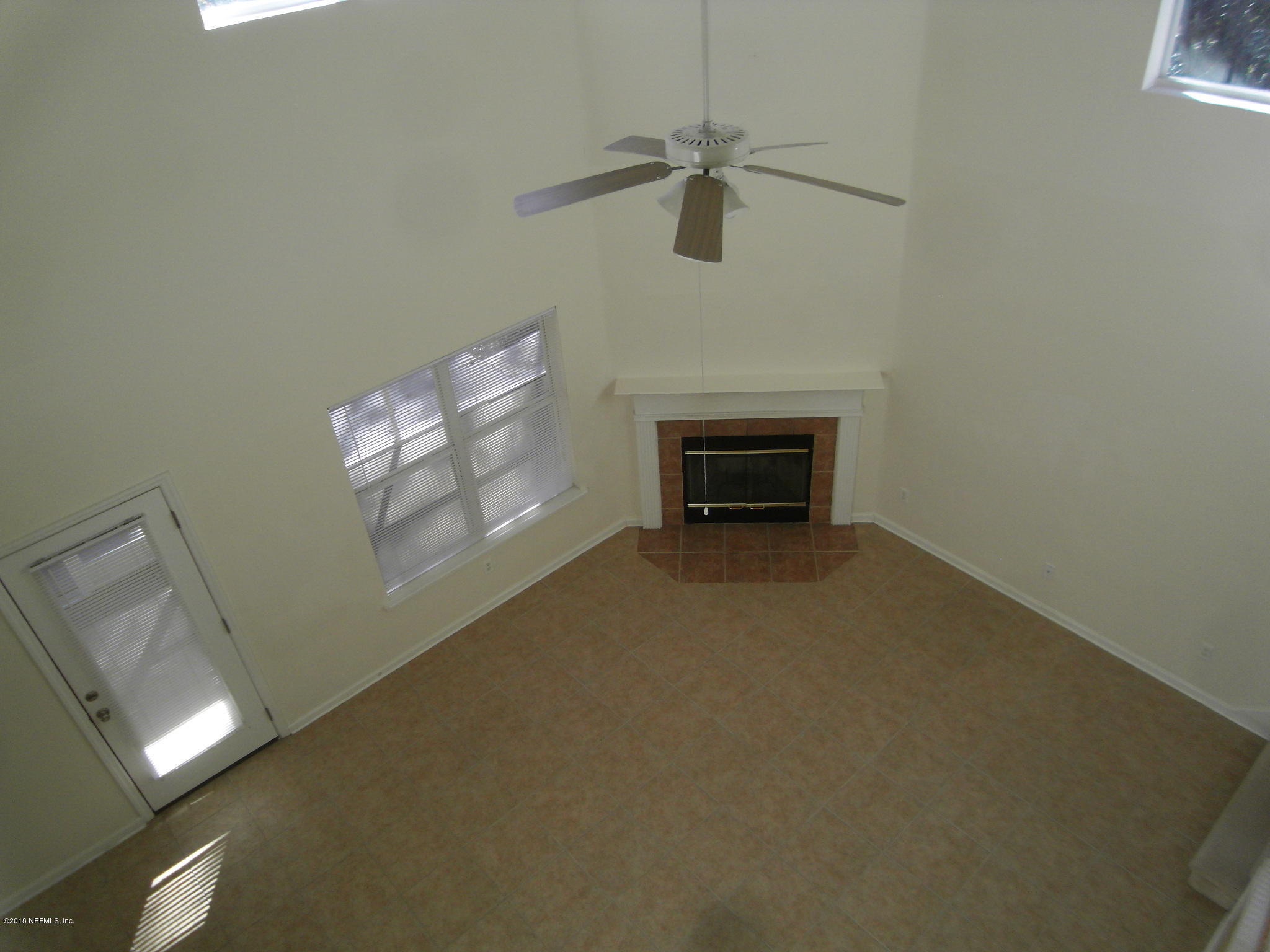 10142 Sandler Road Jacksonville, FL 32222 - Photo 18 of 33 en empty room with windows and fireplace