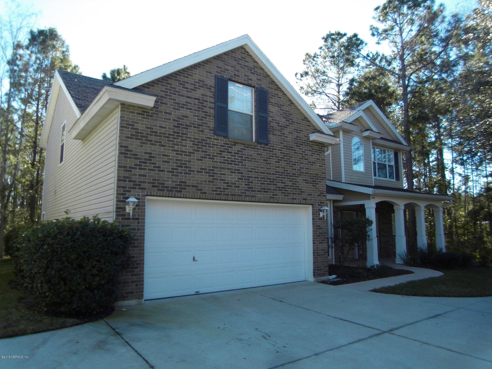 10142 Sandler Road Jacksonville, FL 32222 - Photo 2 of 33 a front view of a house with a yard and garage