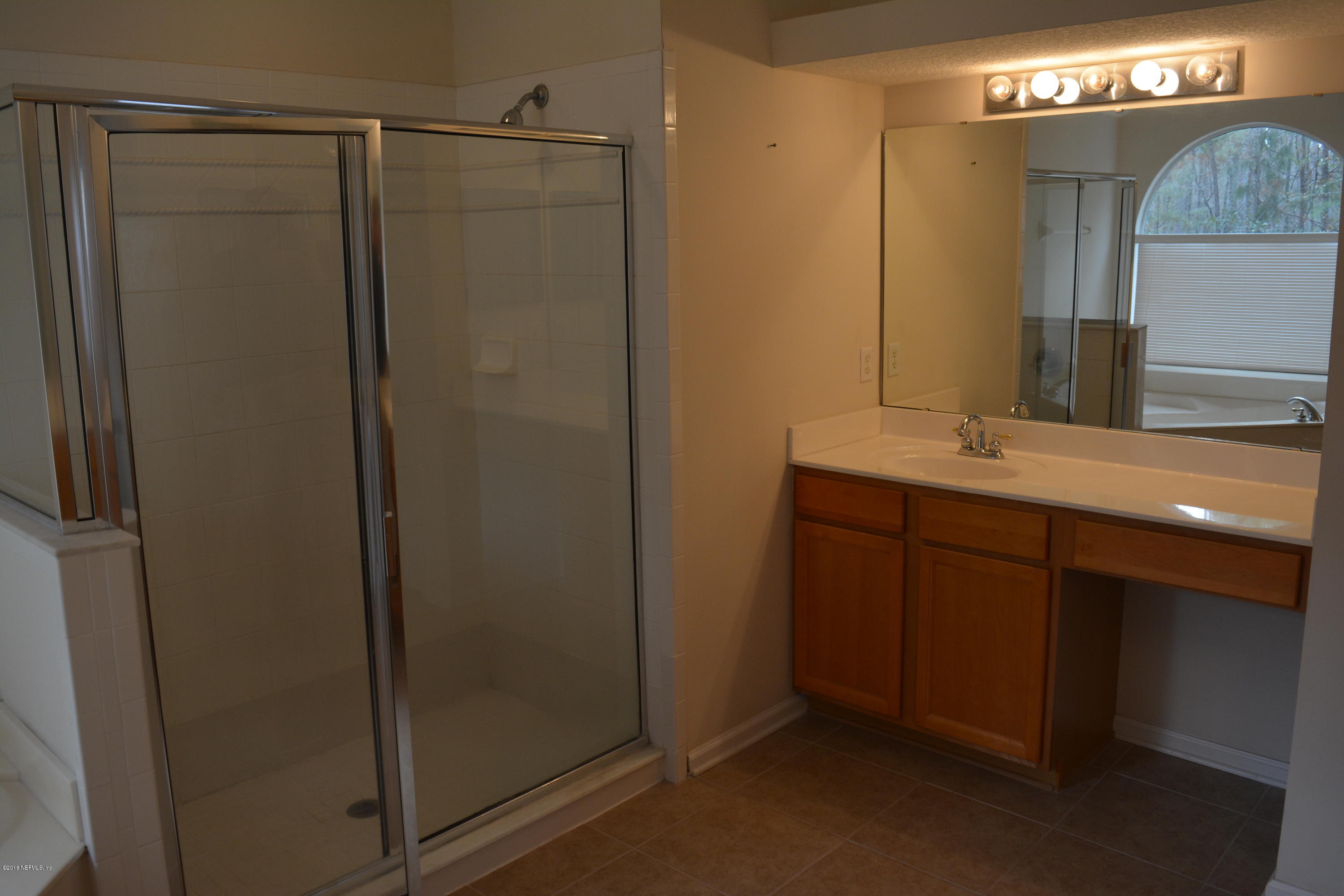 10142 Sandler Road Jacksonville, FL 32222 - Photo 22 of 33 a bathroom with a mirror a sink and vanity