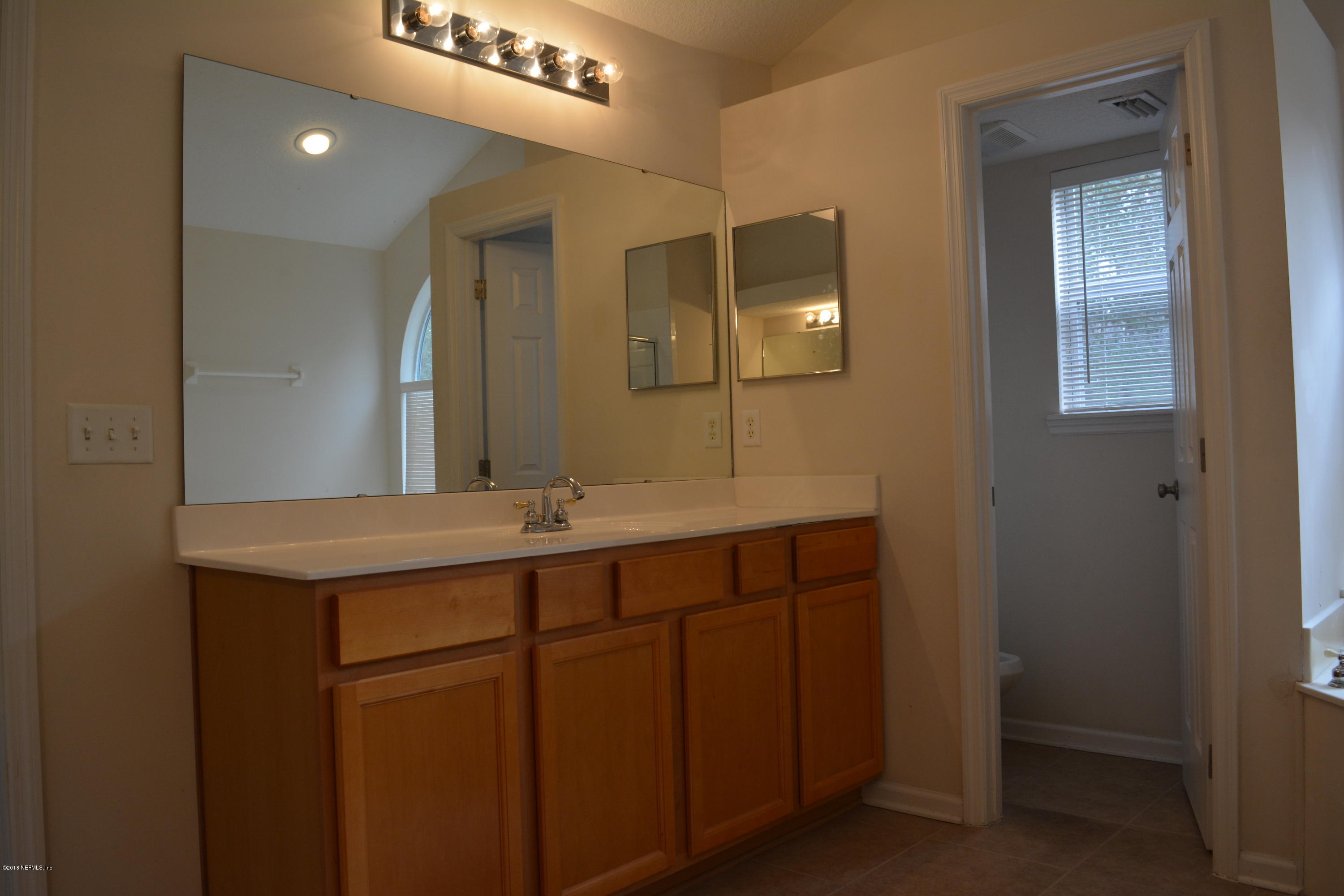10142 Sandler Road Jacksonville, FL 32222 - Photo 26 of 33 a bathroom with a double vanity sink and a mirror