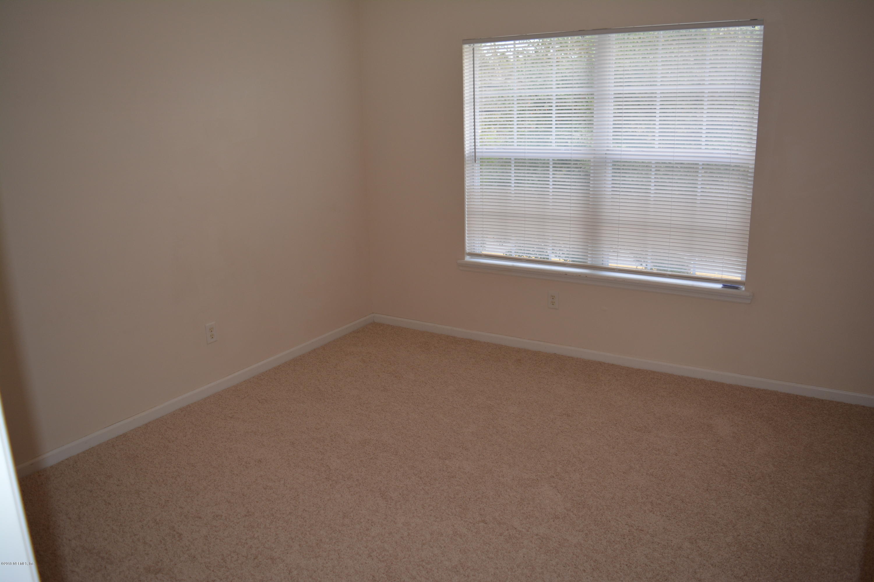 10142 Sandler Road Jacksonville, FL 32222 - Photo 28 of 33 an empty room with a window