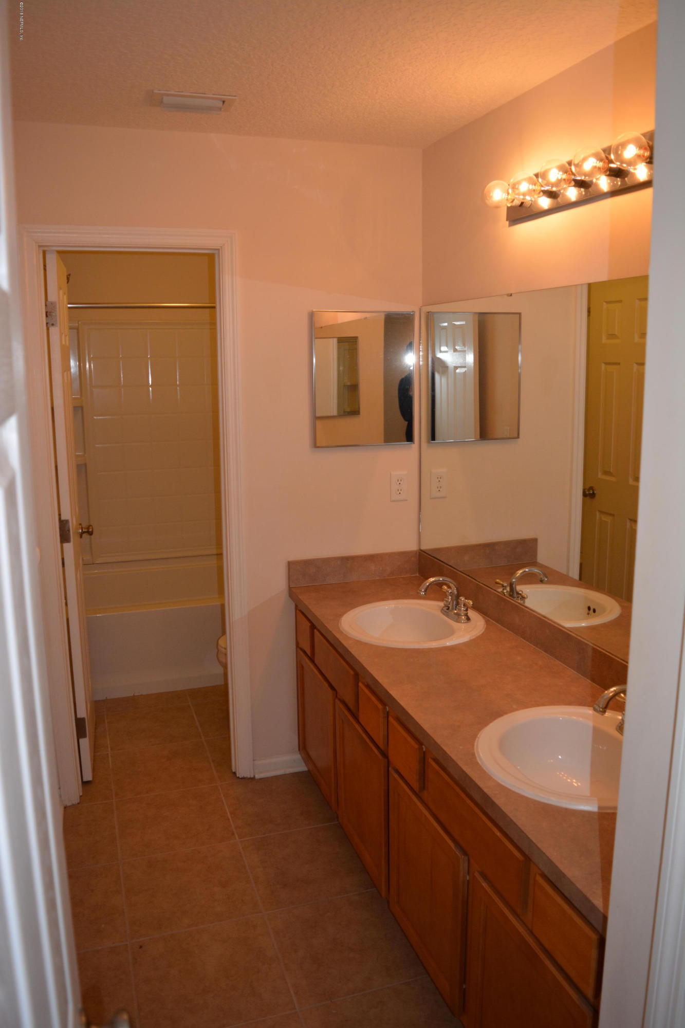10142 Sandler Road Jacksonville, FL 32222 - Photo 30 of 33 a bathroom with a granite countertop sink and a mirror