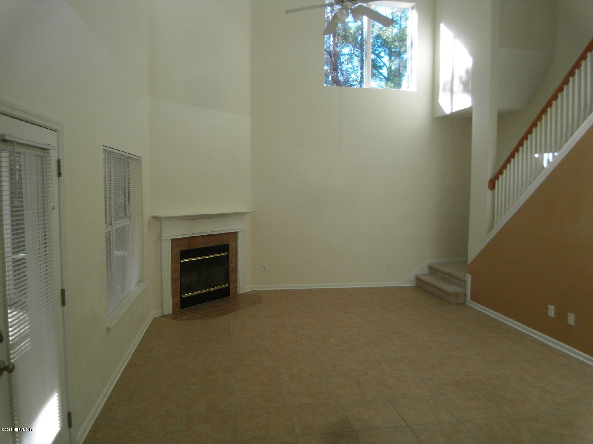 10142 Sandler Road Jacksonville, FL 32222 - Photo 6 of 33 a view of an empty room with a fireplace and a window