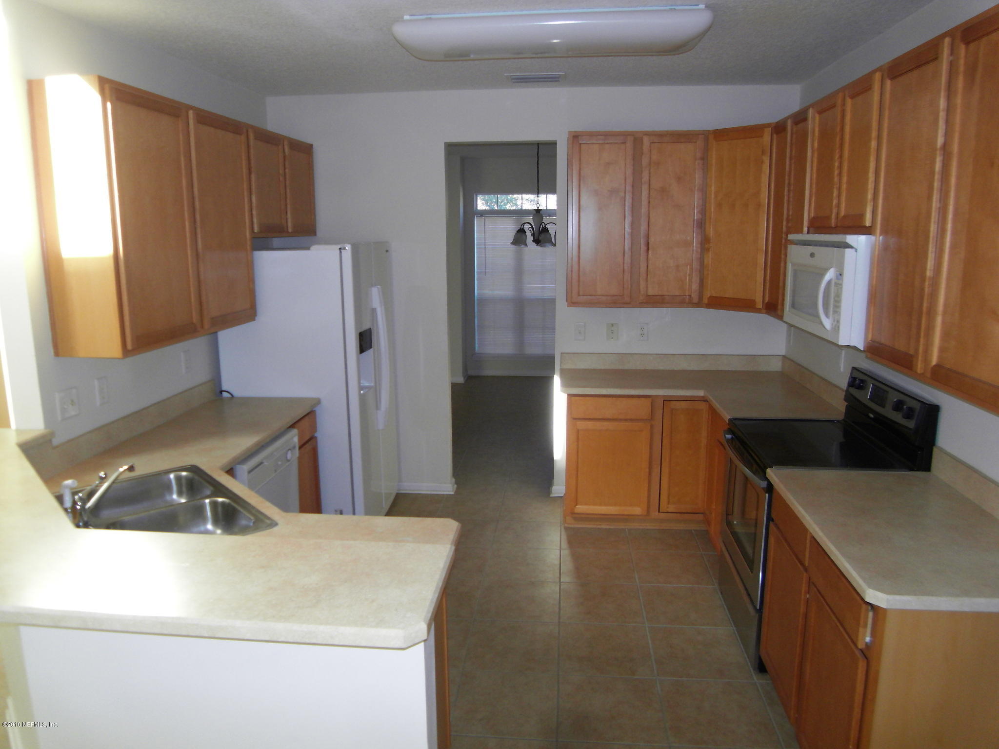 10142 Sandler Road Jacksonville, FL 32222 - Photo 9 of 33 a kitchen that has a sink and a stove in it