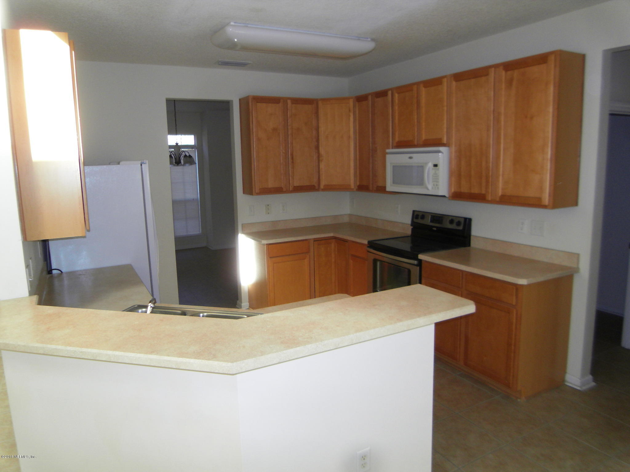 10142 Sandler Road Jacksonville, FL 32222 - Photo 10 of 33 a kitchen with stainless steel appliances granite countertop a sink stove and refrigerator