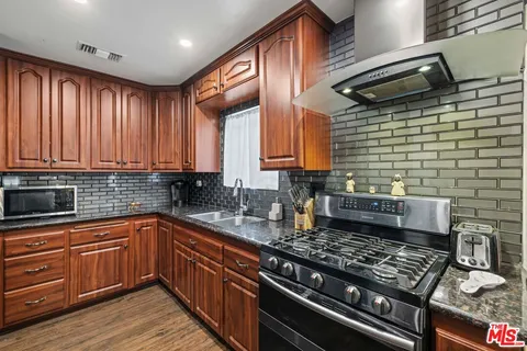 a kitchen with a sink stove and cabinets