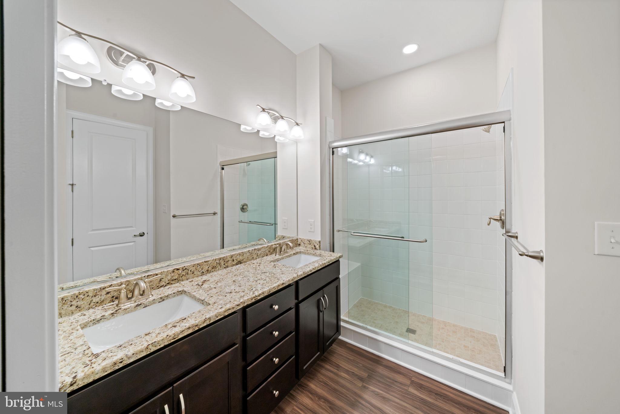 627 Appaloosa Road, Unit 251 Downingtown, PA 19335 - Photo 13 of 34 a bathroom with a granite countertop sink mirror and a shower