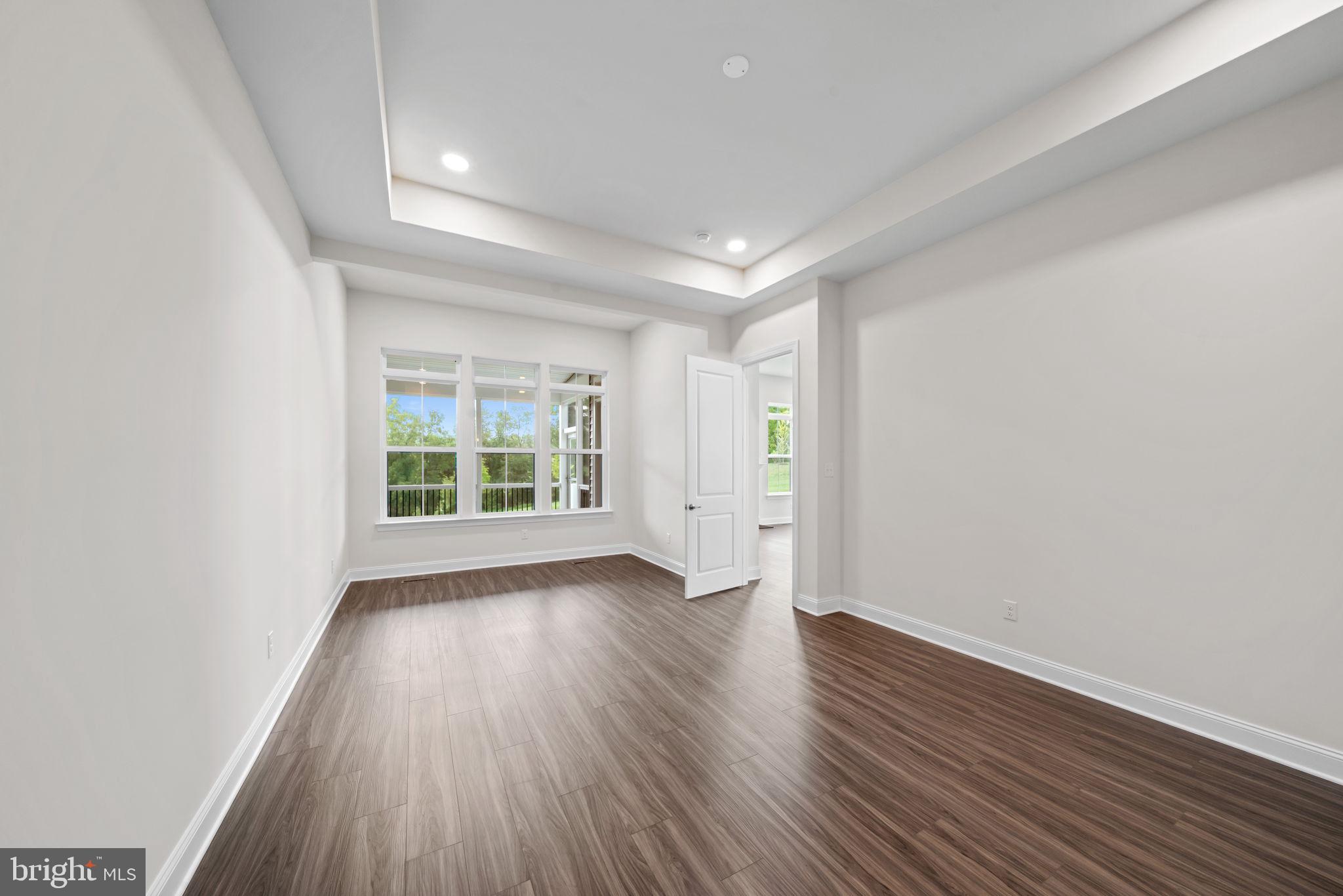 627 Appaloosa Road, Unit 251 Downingtown, PA 19335 - Photo 16 of 34 an empty room with wooden floor and windows