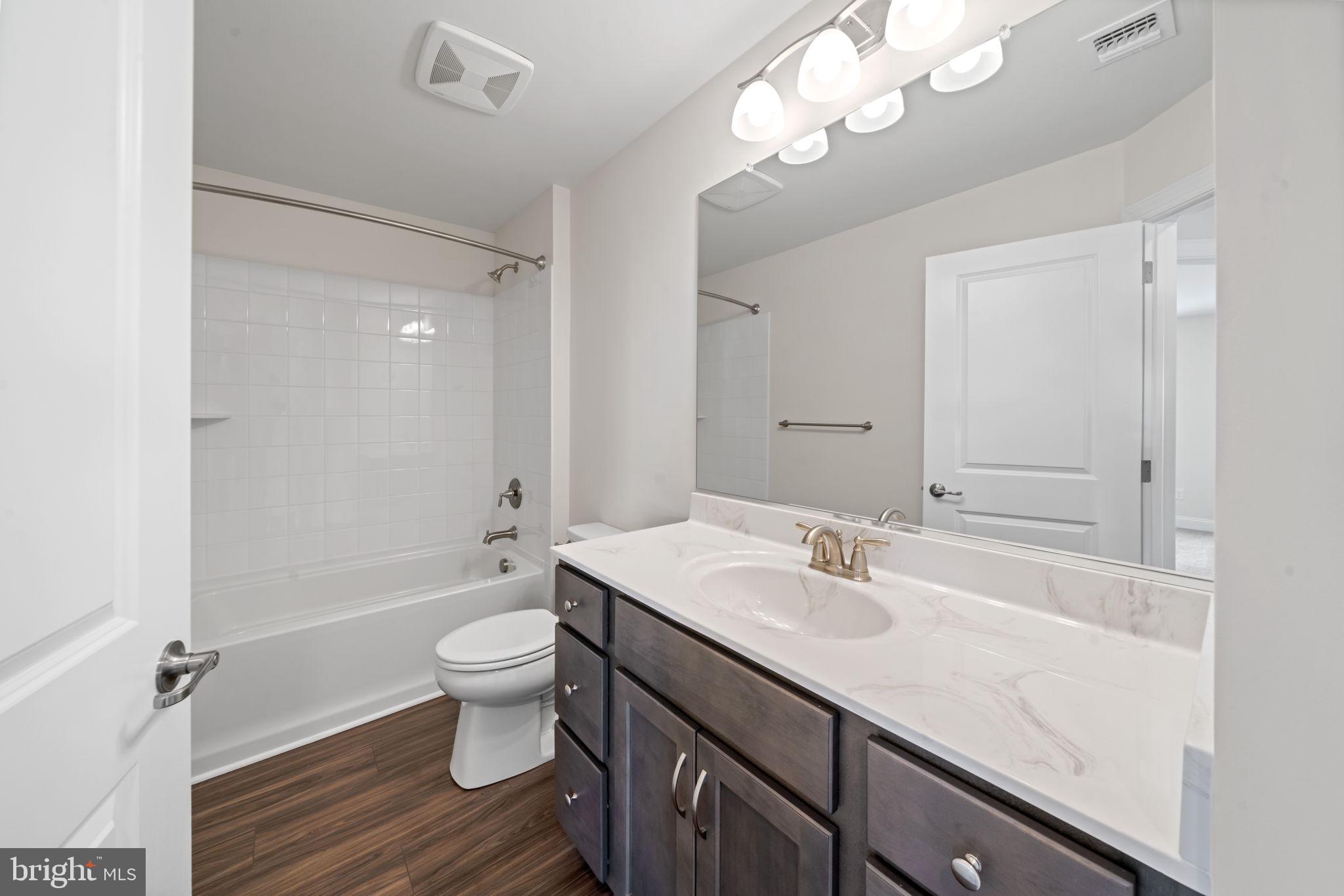 627 Appaloosa Road, Unit 251 Downingtown, PA 19335 - Photo 28 of 34 a bathroom with a sink a toilet a mirror and shower