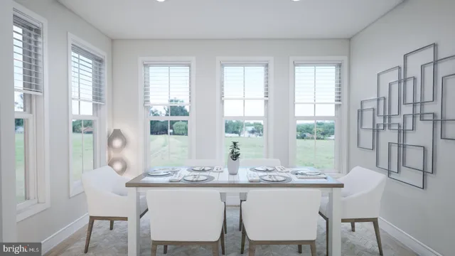 a dining room with table chairs and wooden floor