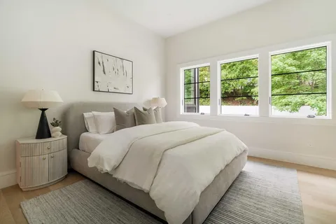 a bedroom with bed and a window