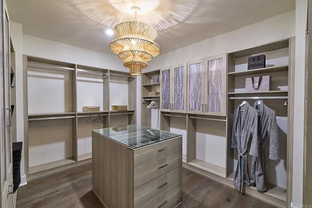 a kitchen with a refrigerator and a chandelier