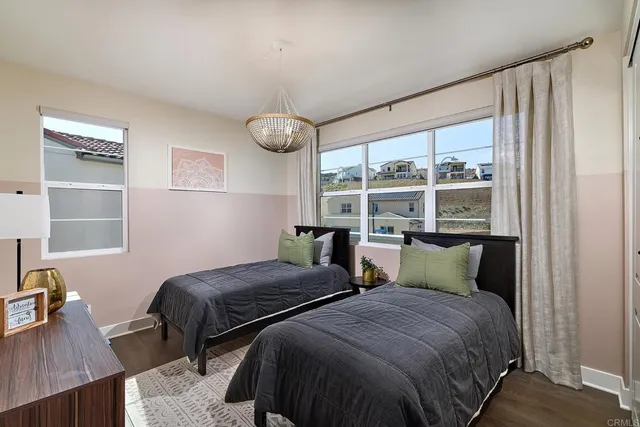 a bedroom with two beds and a large window