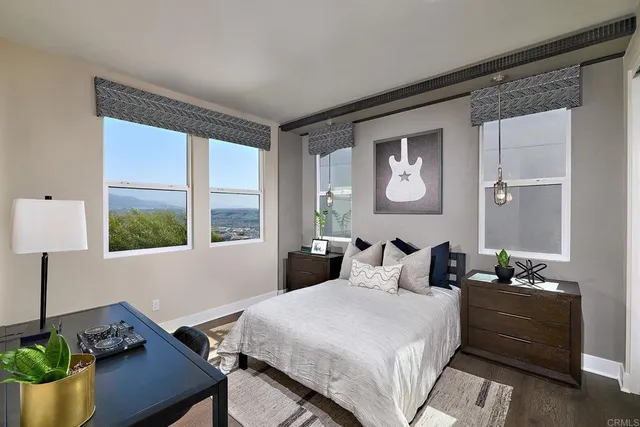 a bedroom with a bed and a potted plant