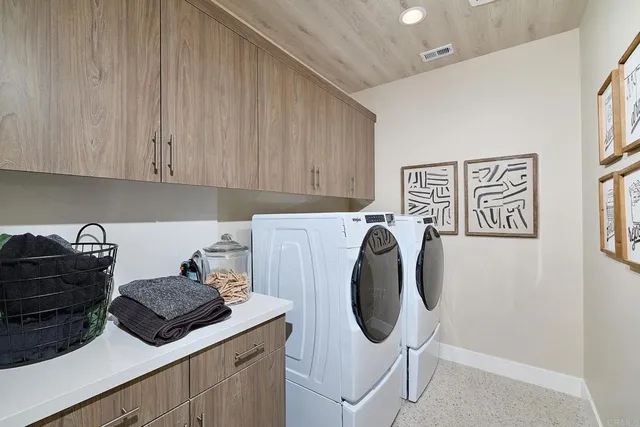 a view of a storage and utility room with washer and dryer